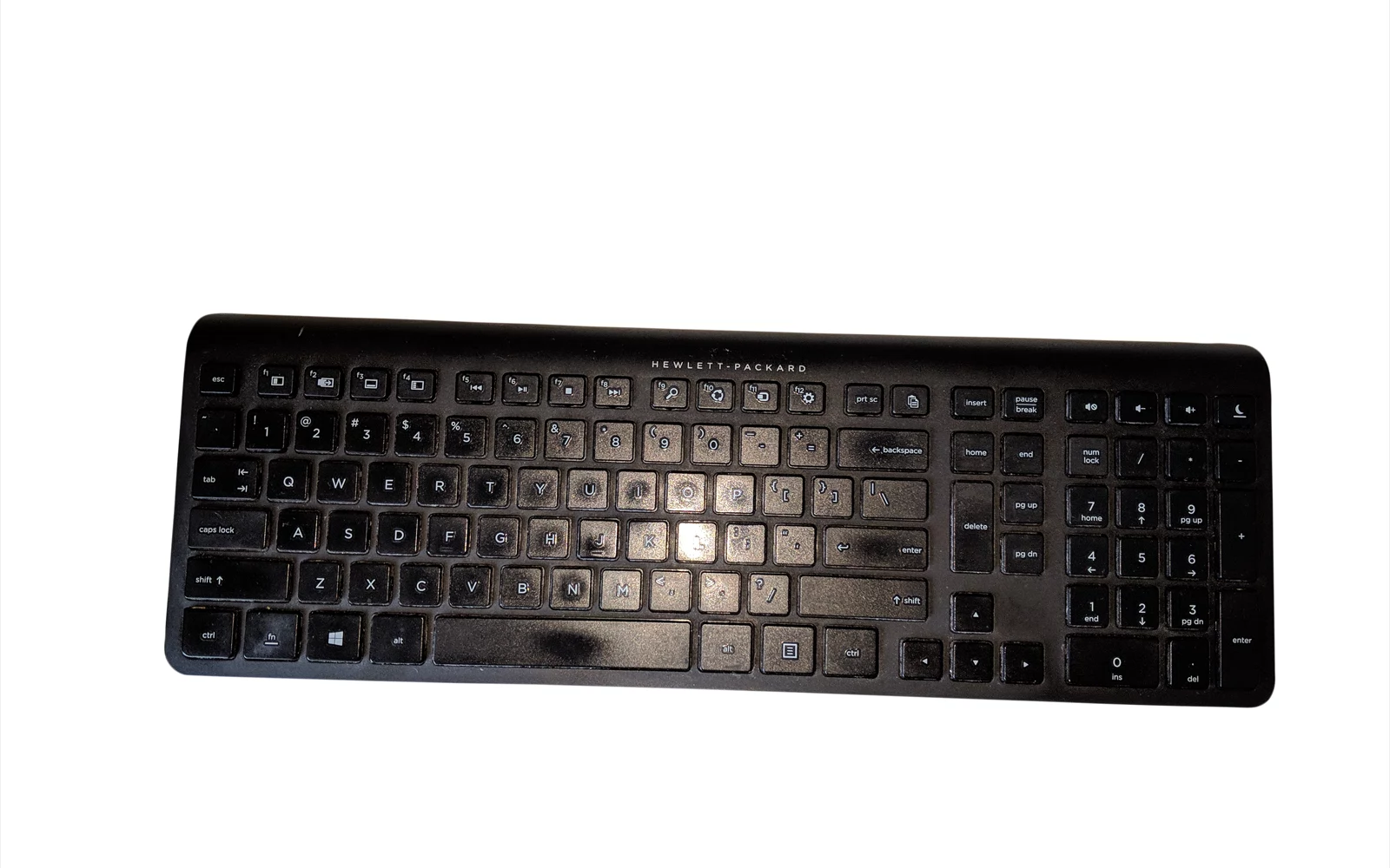 Svart trådløst tastatur med tallfelt, sett ovenfra mot hvit bakgrunn.